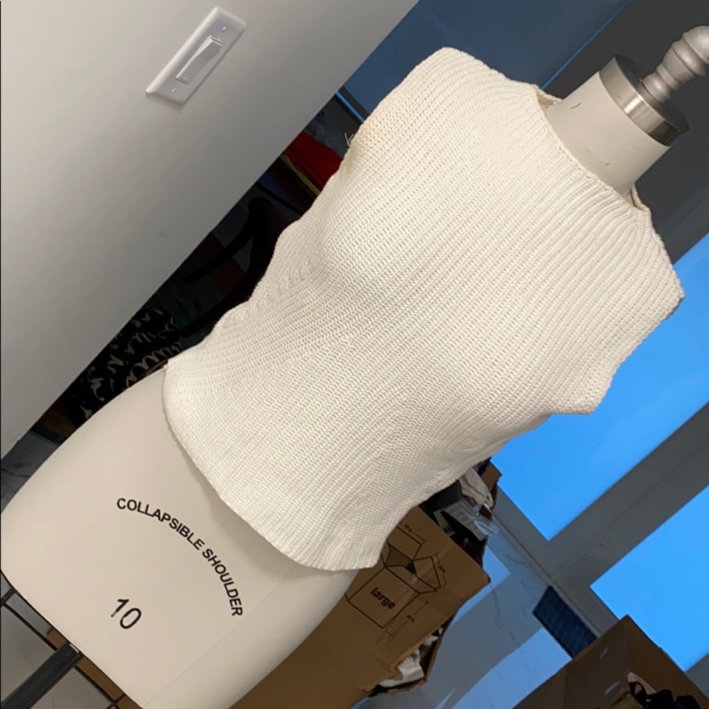 White sleeveless sweater top